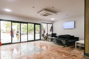 a living room with a couch and a tv at Lara World Hotel in Antalya