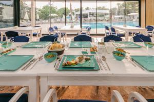 a white table with plates of food on it at Lara World Hotel in Antalya