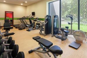 a gym with a lot of exercise equipment in it at Hampton by Hilton Warsaw Airport in Warsaw