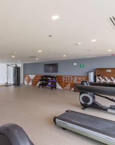 a gym with a treadmill and a flat screen tv at Hampton by Hilton Aguascalientes Downtown in Aguascalientes