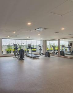 a gym with treadmills and ellipticals in a building at Hampton by Hilton Aguascalientes Downtown in Aguascalientes +32 photos