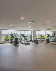 a gym with treadmills and ellipticals in a building at Hampton by Hilton Aguascalientes Downtown in Aguascalientes