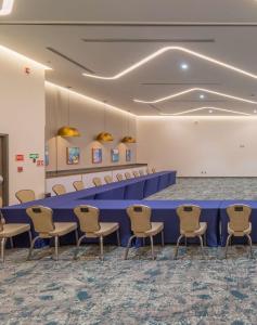 a conference room with a long blue table and chairs at Hampton by Hilton Aguascalientes Downtown in Aguascalientes