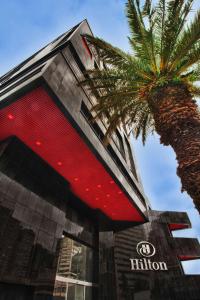 a building with a palm tree in front of it at Hilton Bogotá in Bogotá