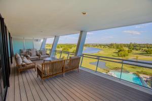 a balcony of a house with a view of a golf course at Hilton Pilar in Pilar
