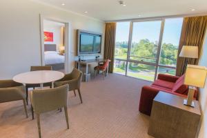 a hotel room with a bed and a table and chairs at Hilton Pilar in Pilar