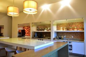 a large kitchen with a large counter with stools at Hampton Inn by Hilton Ciudad del Carmen in Ciudad del Carmen