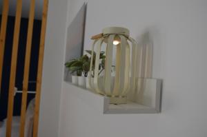 uma luz numa parede com uma planta num nicho em Open Space Centralissimo Nettuno fronte Porto em Nettuno