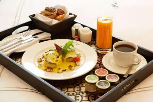 a tray with a plate of food and a cup of coffee at Hilton Lima Miraflores in Lima