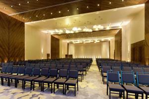 a large room with blue chairs and a stage at Hilton Mexico City Santa Fe in Mexico City