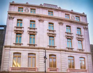 a large white building with a sign on it at Umbral, Curio Collection By Hilton in Mexico City