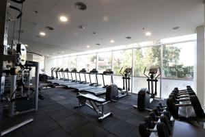 a gym with a row of treadmills and machines at Hilton Garden Inn Neuquen in Neuquén