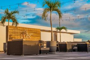 un restaurant avec des palmiers en face d'un bâtiment dans l'établissement Hilton Trinidad & Conference Centre, à Port-d'Espagne