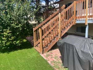 a wooden deck with a cover next to a house at MileHi Vacation Home in Aurora