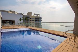 a large swimming pool on the roof of a building at Hilton Garden Inn Santa Marta in Santa Marta