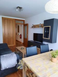 a living room with a table and a couch at Apartamento Bulevar in Burgos