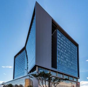 a tall building with glass windows on the side of it at Hilton Bogota Corferias in Bogotá