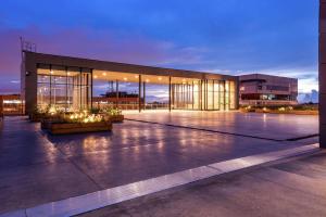 a large building with lights in front of it at Hilton Bogota Corferias in Bogotá