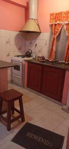 a kitchen with a stove and a table in it at Hospedaje El Turista. in Libertador General San Martín