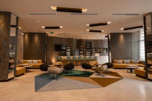 a lobby with couches and chairs and a counter at Hilton Garden Inn Lima Miraflores in Lima