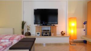 a living room with a flat screen tv on a wall at Ferienwohnung Dresden Trachenberge in Dresden