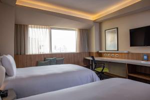 Cama ou camas em um quarto em Hilton Garden Inn Lima Miraflores