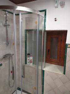 a shower with a glass door in a bathroom at Casa-Mirador La Alhacena in Granada