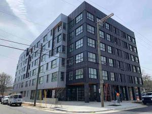 a large black building on the corner of a street at Modern Queen Bed & Twin Futon Studio with WiFi, Kitchen, Washer, and Dryer in Charlotte