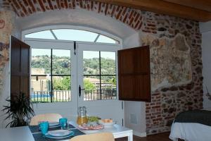a kitchen with a table and a large window at El Esquileo in Buitrago del Lozoya