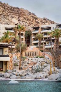 a view of a resort with palm trees and water at Waldorf Astoria Los Cabos Pedregal in Cabo San Lucas