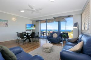 a living room with a blue couch and chairs at Nautilus 5 in Hawks Nest