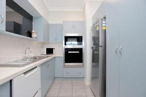 a kitchen with white cabinets and a refrigerator at Nautilus 5 in Hawks Nest