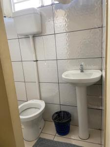 a bathroom with a toilet and a sink at Stylo Hotel in Juiz de Fora