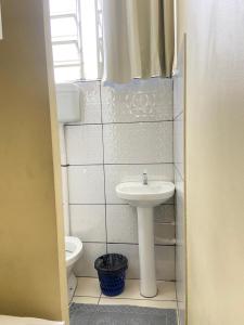 a bathroom with a sink and a toilet at Stylo Hotel in Juiz de Fora