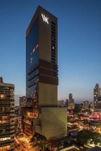 a tall building with a sign on it in a city at Waldorf Astoria Panama in Panama City