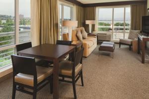 a living room with a couch and a table and chairs at DoubleTree by Hilton Hotel Boston Bayside in Boston