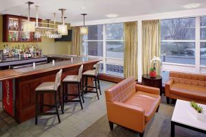 a bar with brown chairs and a bar counter at DoubleTree by Hilton Hotel Boston Bayside in Boston