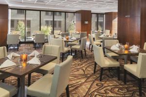 a restaurant with tables and chairs and windows at DoubleTree by Hilton Hotel Boston - Downtown in Boston