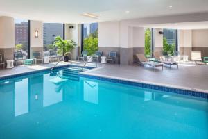 a swimming pool in a hotel with views of the city at Hampton Inn Boston Seaport District in Boston