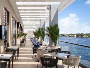 a restaurant with tables and chairs and a view of the water at Hilton Fort Lauderdale Marina in Fort Lauderdale +63 photos