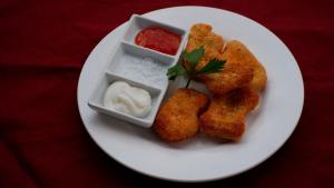 a plate of food with some fried food and condiments at Wisnu Lumbung Uluwatu in Uluwatu