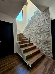 a staircase in a house with a stone wall at Colinas Casa en la Playa in Puerto Peñasco