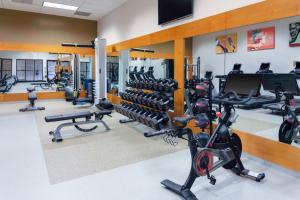 a gym with treadmills and elliptical machines at DoubleTree by Hilton Kansas City - Overland Park in Overland Park