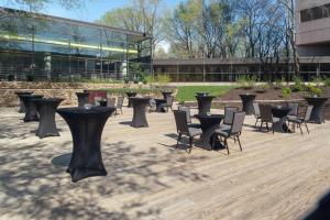 a group of tables and chairs in front of a building at DoubleTree by Hilton Kansas City - Overland Park in Overland Park