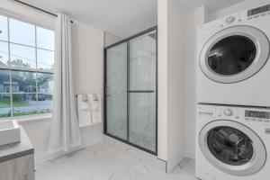 a white laundry room with a washer and dryer at Beautiful Lakeside Haven in Port Hope