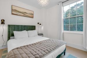 a bedroom with a large bed and a window at Beautiful Lakeside Haven in Port Hope
