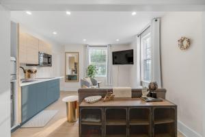 a living room with a couch and a kitchen at Beautiful Lakeside Haven in Port Hope
