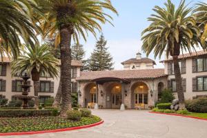 a resort with palm trees in front of a building at Embassy Suites by Hilton Napa Valley in Napa