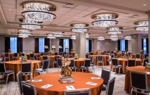 a banquet hall with tables and chairs and chandeliers at Hilton Minneapolis in Minneapolis