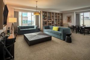 a living room with a couch and a table at The Duniway Portland, A Hilton Hotel in Portland